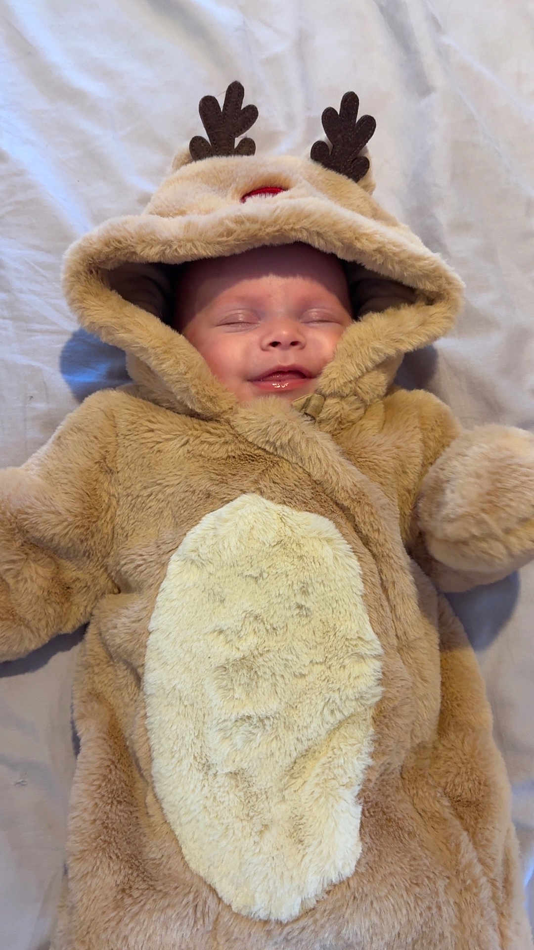 Lilly-Joan joined the competition — help win amazing prizes! antlers, baby, bed, blanket, child, closed_eyes, costume, cozy, cute, face, fur, hood, indoors, infant, lying_down, reindeer, sleeping, smiling, soft, warm
