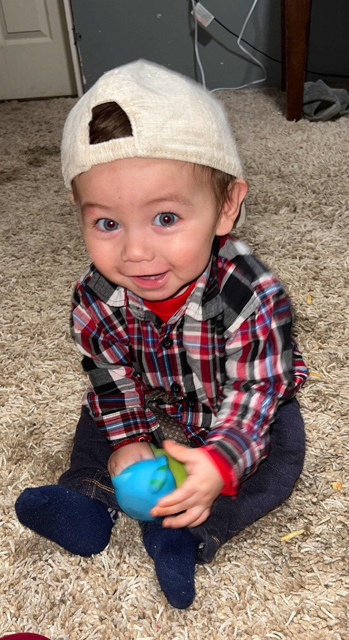 Hector is registered to the contest to win money with this photo: baby, baby_toddler_clothing, cap, child, cool, electric_blue, eye, face, flash_photography, fun, grass, happy, head, headgear, headwear, joy, pattern, person, plaid, sleeve