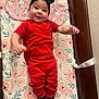Avory is registered to the contest to win money with this photo: baby, infant, red_clothing, headband, black_bow, smiling, lying_down, changing_pad, floral_pattern, socks, cute, happy, indoor, wooden_furniture, child, person, portrait, baby_girl, apparel, cozy