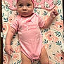 Avory joined the competition — help win amazing prizes! baby, infant, pink_onesie, headband, flower, floral_pattern, changing_pad, sock, cute, portrait, child, person, laying_down, indoors, soft_toys, pink, skin, apparel, face, eyes