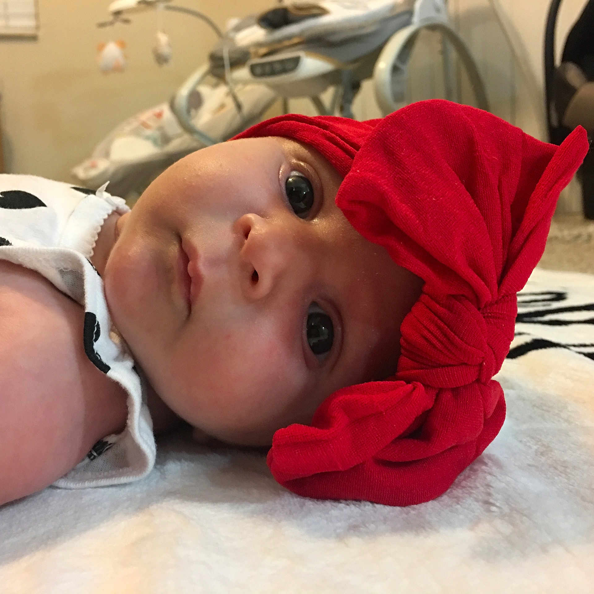 Lana is registered to the contest to win money with this photo: cheek, child, ear, eye, face, forehead, head, headgear, infant, lip, mouth, nose, product, red, skin, smile, textile, toddler