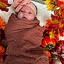 baby, infant, swaddle, headband, pink_bow, autumn, fall_leaves, pumpkin, orange, brown, blanket, cute, portrait, outdoor, seasonal, decoration, child, wrapped, newborn, soft