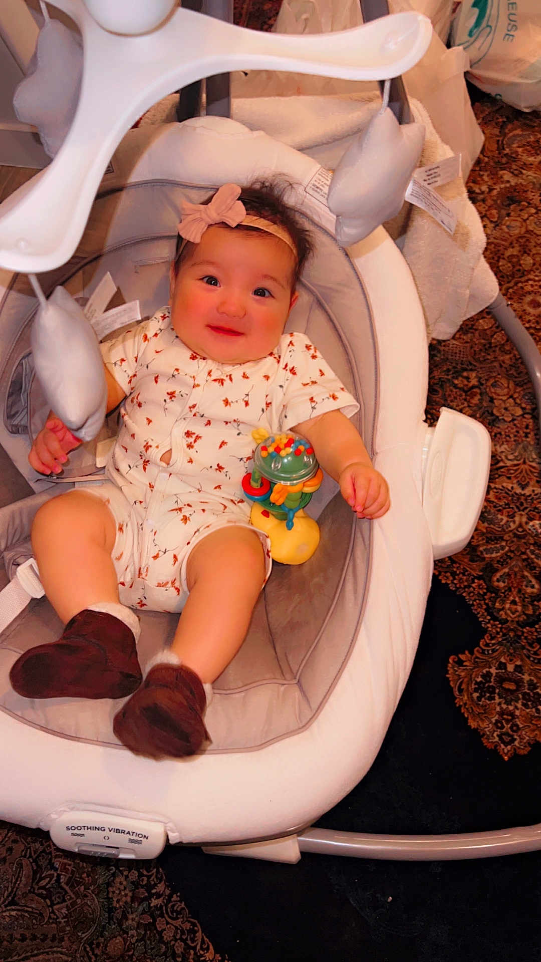 Aylin joined the competition — help win amazing prizes! baby, infant, child, baby_rocker, toy, headband, clothing, footwear, carpet, indoor, smiling, cute, comfort, fabric, seat, childrens_toy, person, happy, home, play
