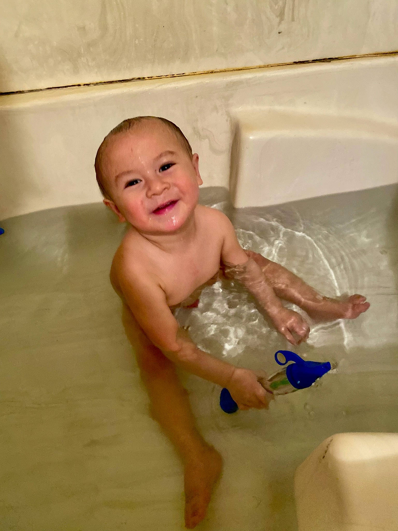Nathaniel is registered to the contest to win money with this photo: baby, baby_bathing, bath_toy, bathing, bathroom, bathtub, chest, child, flooring, fluid, foot, fun, joy, leisure, liquid, person, plumbing, plumbing_fixture, smile, thumb
