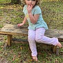 Elizabeth joined the competition — help win amazing prizes! child, curly_hair, bench, outdoor, grass, trees, leaves, barefoot, pants, tshirt, playful, filter, face_filter, devil_horns, nature, wooden_bench, casual_clothing, sitting, daylight, young_child