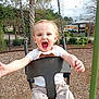 baby, child, clothing, daylight, fun, happy, metal_chains, mulch, nature, outdoor, pants, park, person, play, playground, shirt, smiling, swing, toddler, trees