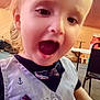 child, toddler, face, smiling, indoor, clothing, vest, bow_tie, happy, person, table, chair, furniture, expression, cute, portrait, young_child, blonde_hair, open_mouth, casual