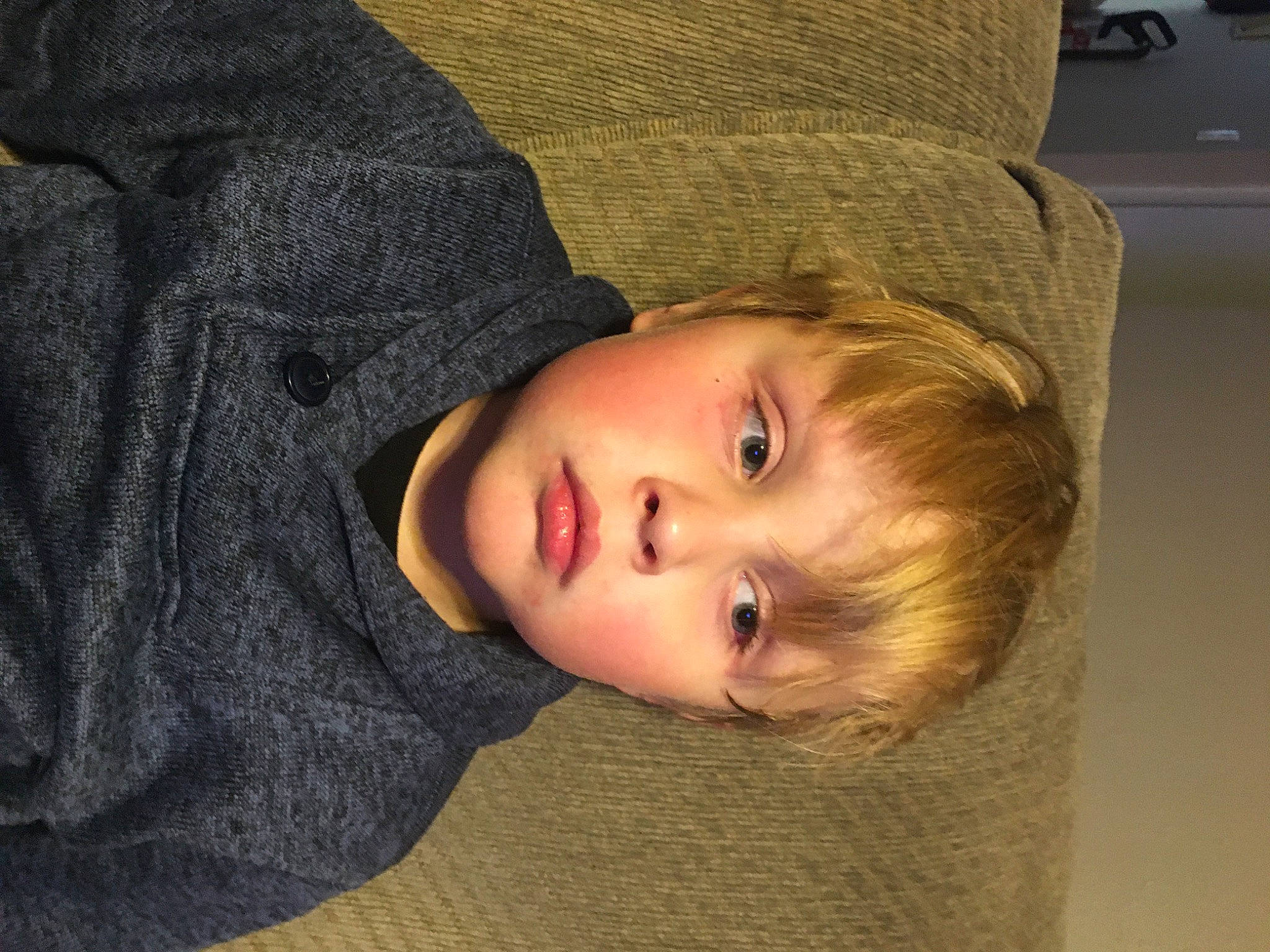 Ryder is registered to the contest to win money with this photo: cheek, child, comfort, eye, eyebrow, flooring, fun, fur, grass, hat, lip, nose, person, portrait_photography, sitting, sleeve, sun_hat, toddler, wheel, wood