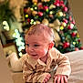 Mayron participe au concours pour gagner de l'argent avec cette photo : baby, bokeh, child, christmas_tree, cozy, cute, festive, happy, holiday, holiday_decor, home, indoors, infant, lying_down, portrait, seasonal, smiling, soft_lighting, striped_sweater, warm_colors