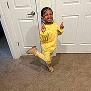 Wylani is registered to the contest to win money with this photo: bodypart, child, clothing, coat, door, face, female, finger, footwear, girl, happy, head, pants, performer, person, photography, portrait, shoe, sitting, soloperformance