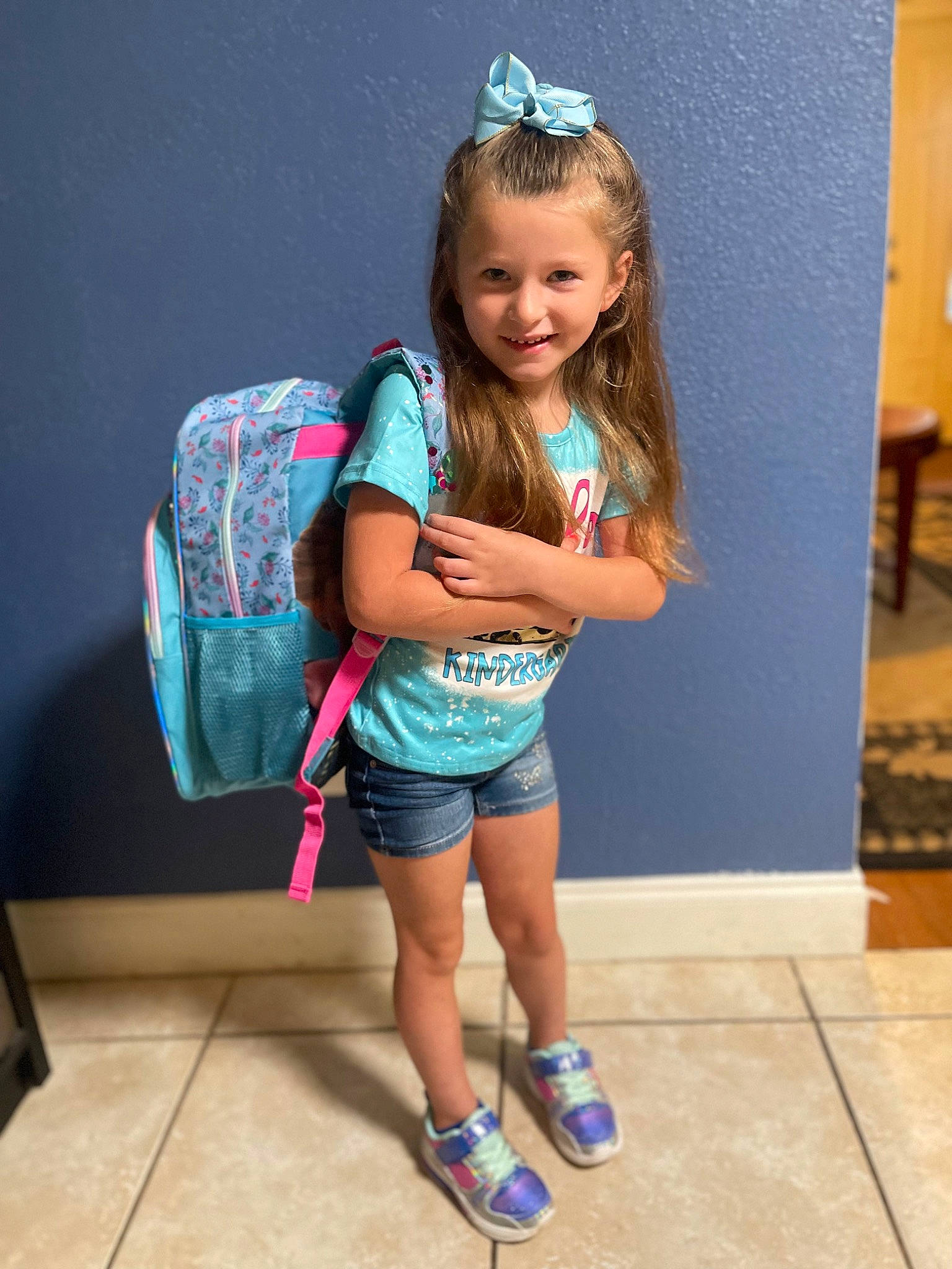 Addilynn is registered to the contest to win money with this photo: abdomen, elbow, electric_blue, fashion_accessory, fun, hair, happy, human_leg, joy, knee, leg, leisure, magenta, person, recreation, shorts, sitting, smile, thigh, toddler