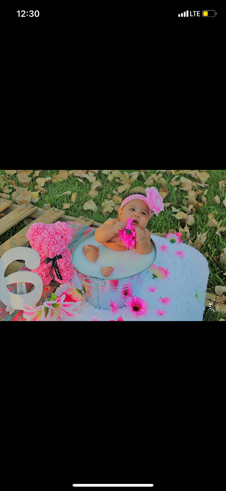 La Niya is registered to the contest to win money with this photo: art, birthday, cap, event, fashion_accessory, font, grass, happy, hat, headwear, leisure, love, magenta, pattern, person, petal, pink, recreation, sitting, sun_hat