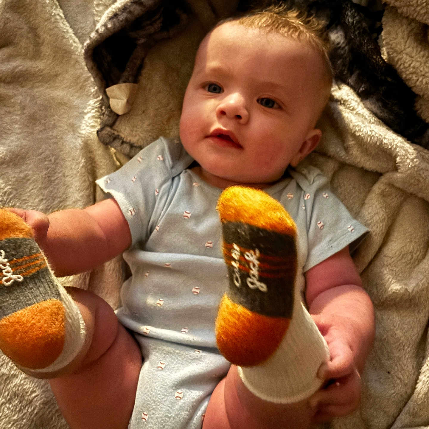 Anthony joined the competition — help win amazing prizes! baby, blanket, child, cozy, cute, face, hands, head, indoor, infant, kicking, legs, light, lying_down, onesie, playful, skin, socks, soft, warm