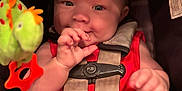 Anthony joined the competition — help win amazing prizes! baby, child, car_seat, red_clothing, plush_toy, toy, infant, face, hand, seatbelt, cute, sitting, indoors, smiling, doll, colorful, portrait, childhood, happy, close_up