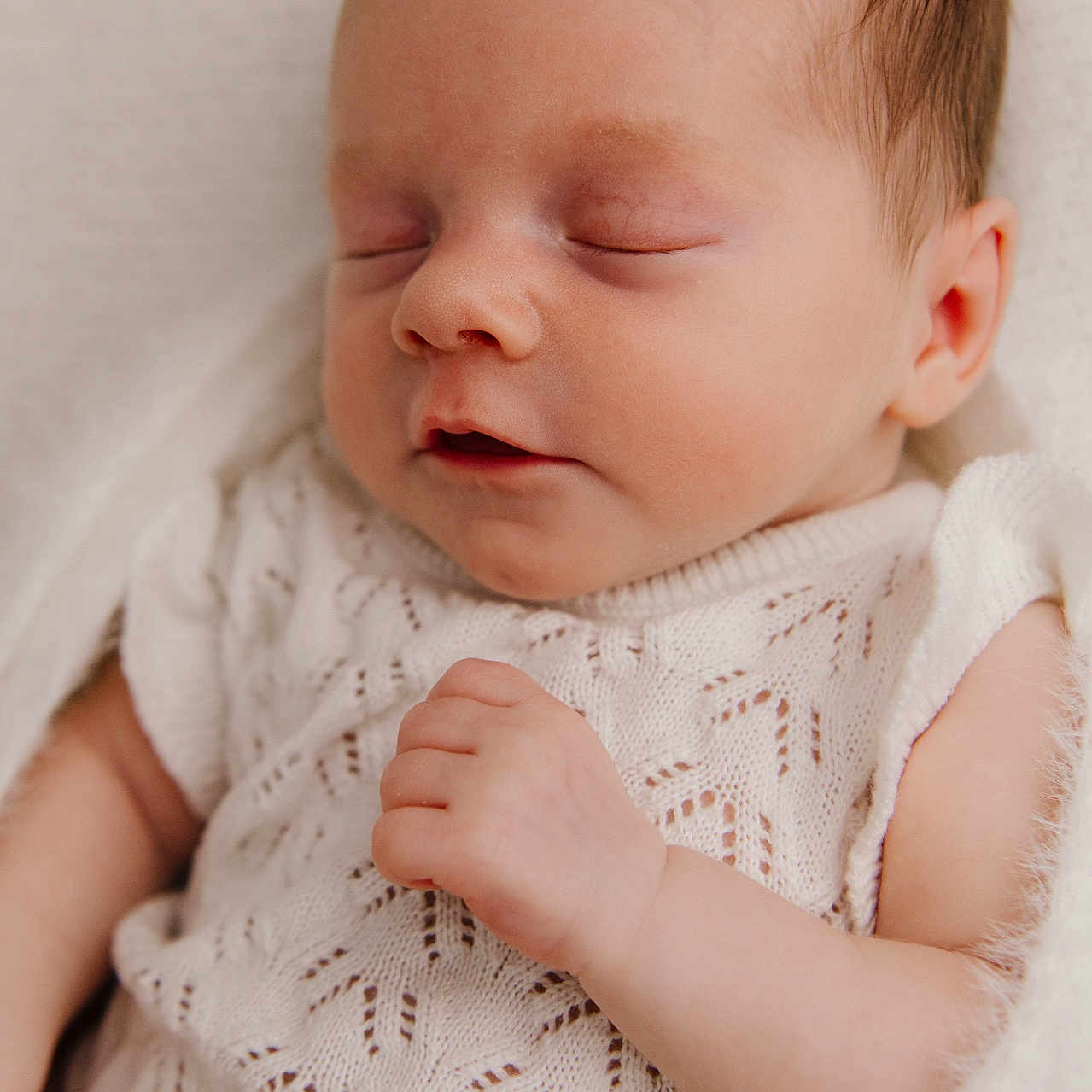 Phoebe is registered to the contest to win money with this photo: baby, blanket, child, closeup, cozy, cute, delicate, face, hand, indoors, infant, knitted, newborn, peaceful, portrait, resting, skin, sleeping, soft_light, white_clothing