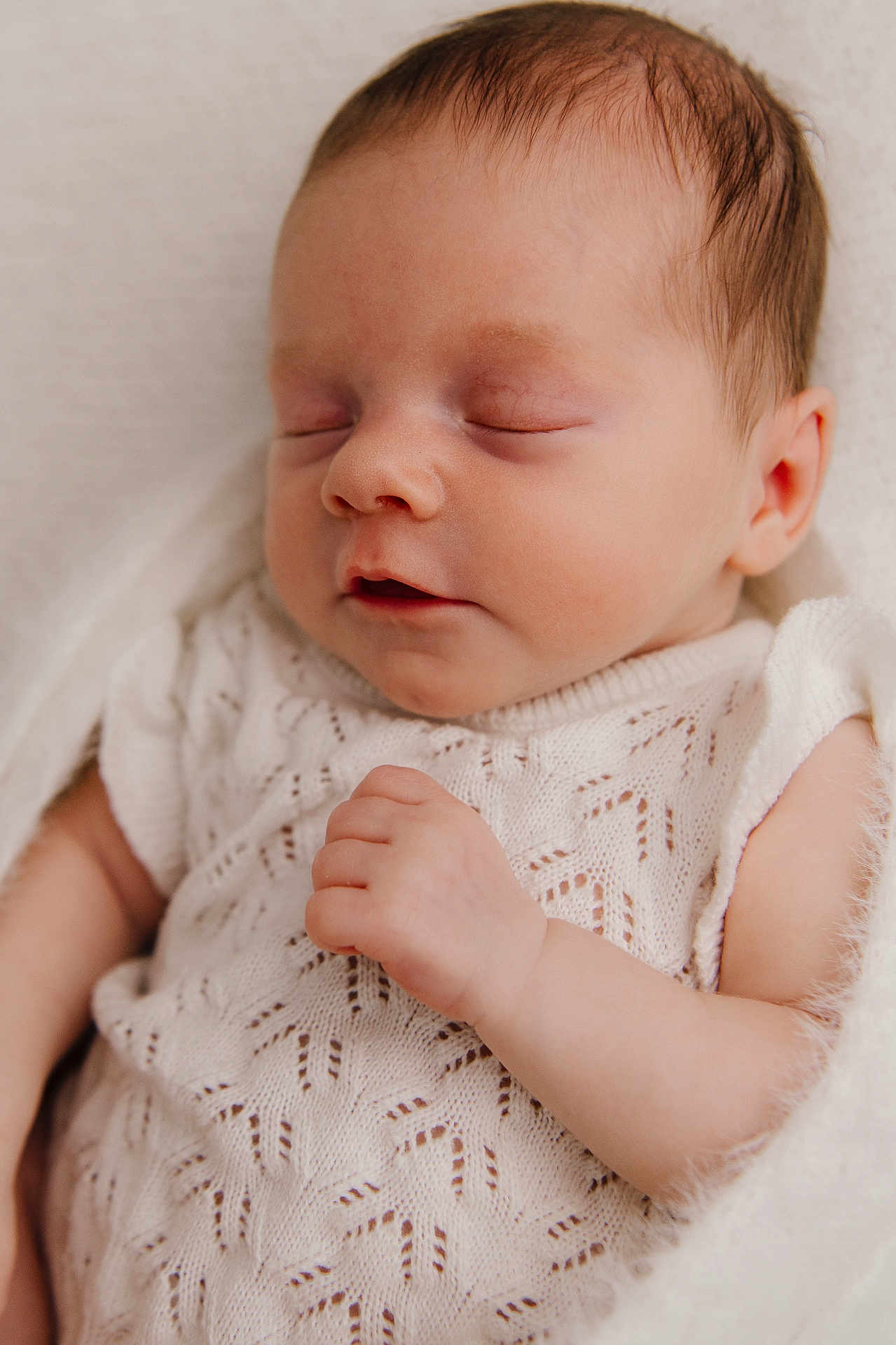 Phoebe is registered to the contest to win money with this photo: baby, newborn, sleeping, infant, white_clothing, knitted, blanket, peaceful, closeup, portrait, child, soft_light, cute, resting, delicate, skin, hand, face, indoors, cozy