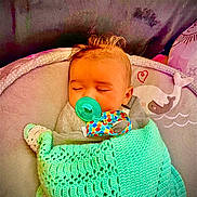 Isla is registered to the contest to win money with this photo: baby, infant, sleeping, pacifier, blanket, crocheted, mint_green, baby_chair, whale, heart, cozy, cute, child, face, head, indoors, comfort, resting, peaceful, toddler