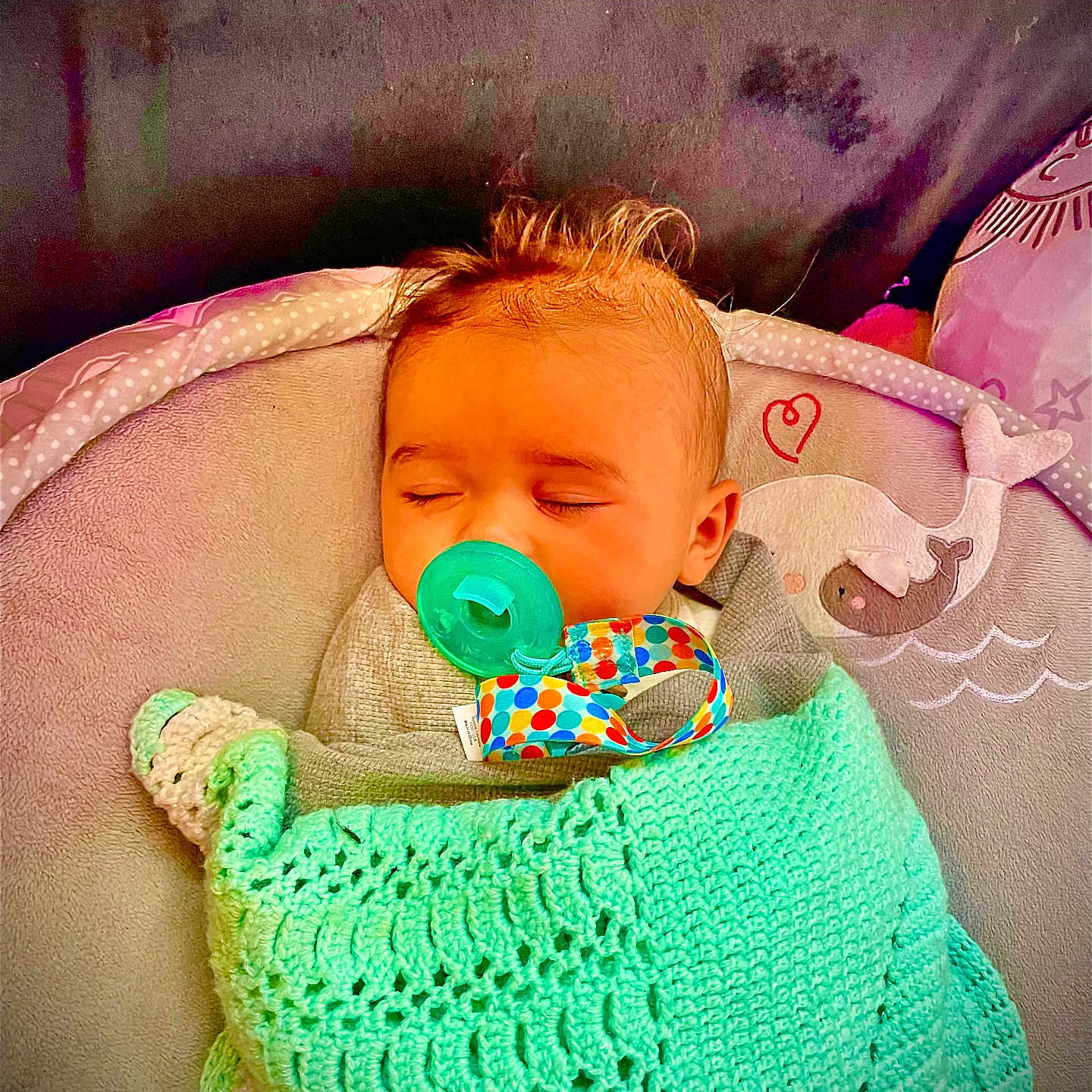 Isla is registered to the contest to win money with this photo: baby, infant, sleeping, pacifier, blanket, crocheted, mint_green, baby_chair, whale, heart, cozy, cute, child, face, head, indoors, comfort, resting, peaceful, toddler