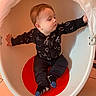 Baïano participe au concours pour gagner de l'argent avec cette photo : alphabet_print, baby, black_clothing, chair, child, comfortable, curious, egg_shaped_chair, floor_tiles, hands, indoor, modern_furniture, portrait, red_seat, short_hair, sitting, socks, toddler, white_chair, young_child