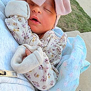 Paulina joined the competition — help win amazing prizes! newborn, baby, sleeping, infant, portrait, pink_hat, mittens, floral_clothing, blanket, swaddled, peaceful, eyes_closed, outdoor, held, adult, soft_blanket, baby_clothing, cozy, pavement, grass