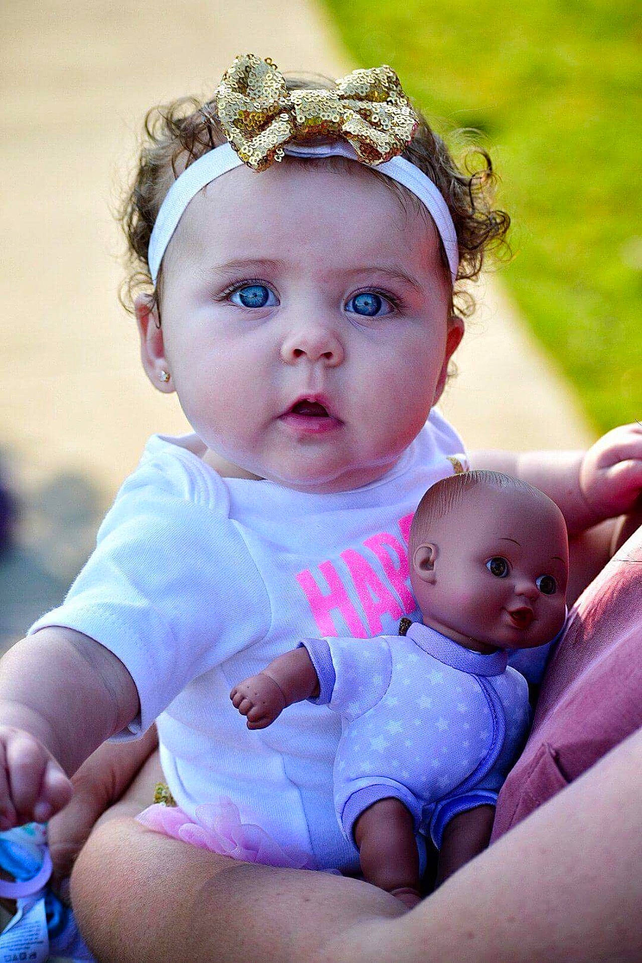 Jayleigh is registered to the contest to win money with this photo: baby_products, beauty, cheek, child, eye, face, fun, girl, hair_accessory, happiness, head, headband, infant, iris, person, pink, product, purple, skin, smile