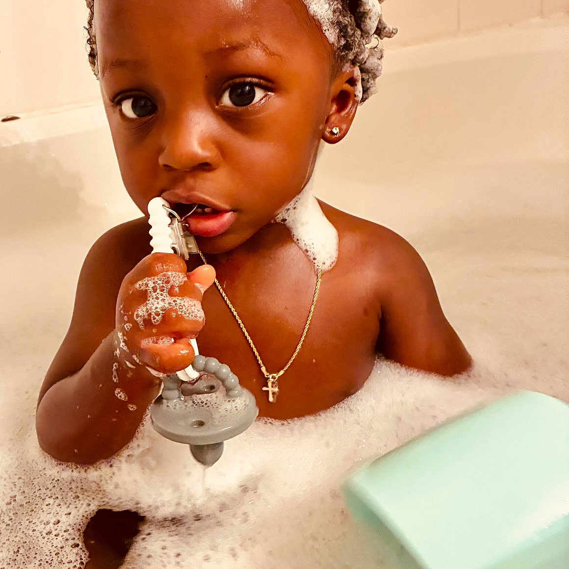 Kross is registered to the contest to win money with this photo: bath, bathroom, bubbles, chain, child, cross, cute, earring, expression, face, foam, hand, head, indoor, necklace, skin, soap, toddler, toy, water