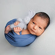 Aram participe au concours pour gagner de l'argent avec cette photo : newborn, baby, infant, wrapped, blue_blanket, knitted_bunny, toys, soft_texture, cute, portrait, resting, peaceful, small_hands, small_feet, face, eyes, indoors, studio_shot, cozy, child