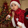 Ayla is registered to the contest to win money with this photo: baby, celebration, child, christmas, christmas_tree, curtain, decorations, festive, floor, hand, holiday, indoor, lights, ornaments, person, presents, red_dress, santa_hat, white_trim, window_blinds