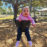 Alany is registered to the contest to win money with this photo: baby, child, flower, happy, headband, jeans, metal_chain, nature, outdoor, park, playground, portrait, seat, smile, socks, stroller, sunlight, swing, tree, wood_chips