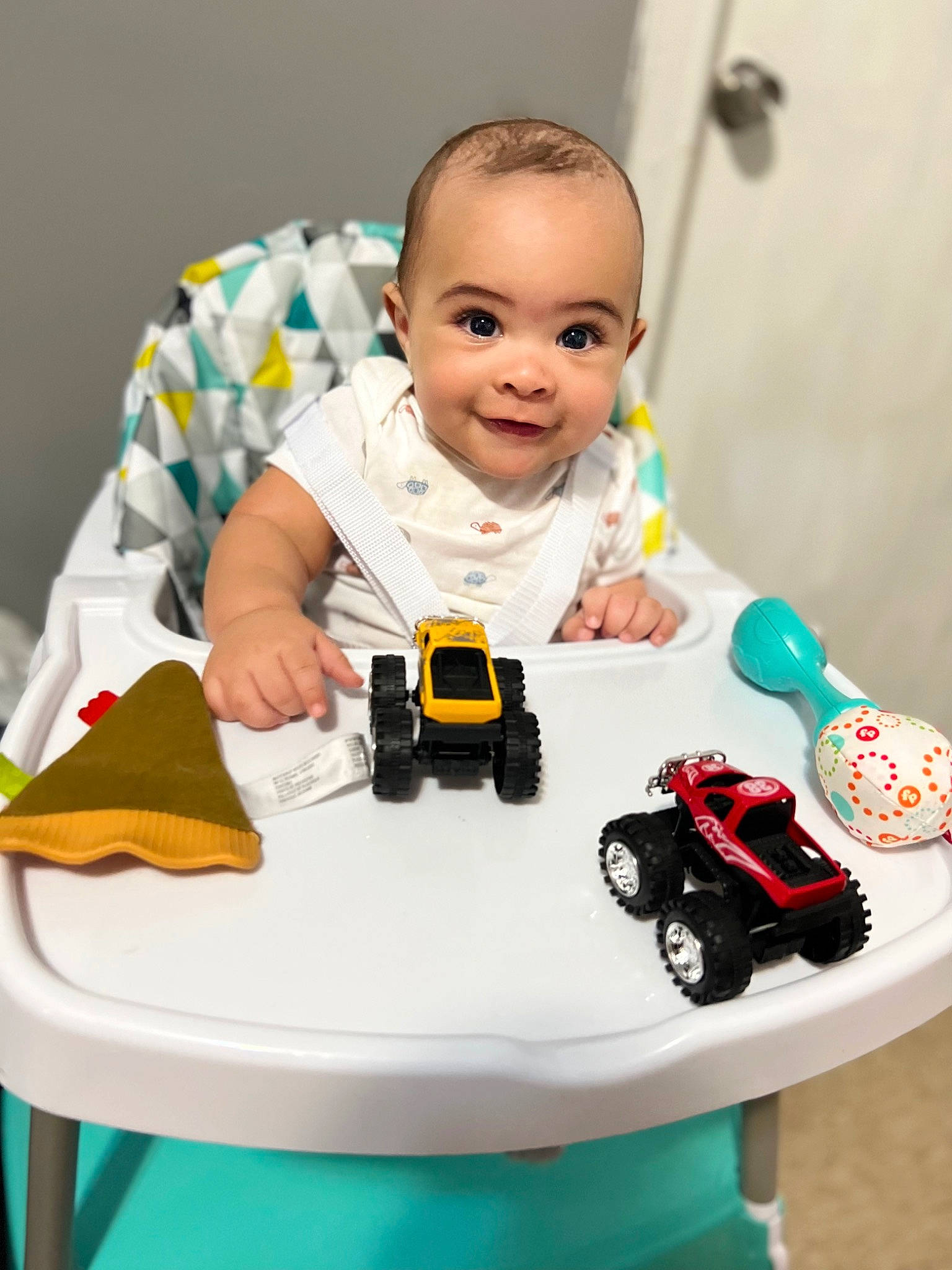 Brian is registered to the contest to win money with this photo: baby, baby_products, baby_toddler_clothing, child, finger, hand, happy, joy, lego, person, product, rolling, sitting, smile, tire, toddler, toy, toy_block, toy_vehicle, wheel