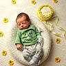 Jackie joined the competition — help win amazing prizes! baby, celebration, cozy, crocheted_flowers, cute, decorative_cake, green_clothing, indoors, infant, knitted_blanket, lying_down, milestone, newborn, peaceful, portrait, ribbon, sleeping, small_baby, soft_texture, yellow_flowers