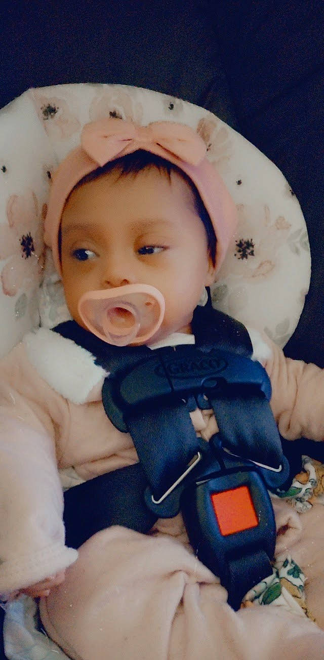 Faith is registered to the contest to win money with this photo: baby, baby_toddler_clothing, cheek, comfort, eye, face, finger, hand, head, human_body, iris, lip, mouth, nose, person, pink, product, skin, sleeve, thumb