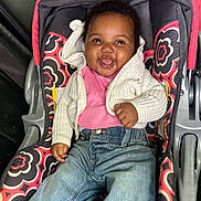Serenity joined the competition — help win amazing prizes! baby, car_seat, casual_wear, child, clothing, cute, happy, indoor, infant, jeans, joyful, knitted, patterned_fabric, person, pink_bib, portrait, seat, smiling, sweater, young_child