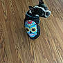 dog, boston_terrier, hoodie, colorful, sugar_skull, day_of_the_dead, pet, animal, wooden_floor, curious, sitting, black_and_white, indoor, cute, small_dog, looking_back, clothing, pattern, ears_up, portrait