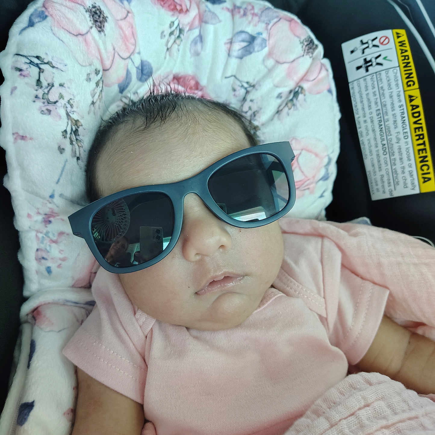 Yvani is registered to the contest to win money with this photo: adorable, baby, baby_seat, child, closeup, cute, floral_cushion, head_support, indoors, infant, infant_fashion, person, pink_clothing, portrait, relaxed, resting, sleepy, small_hands, soft_fabric, sunglasses