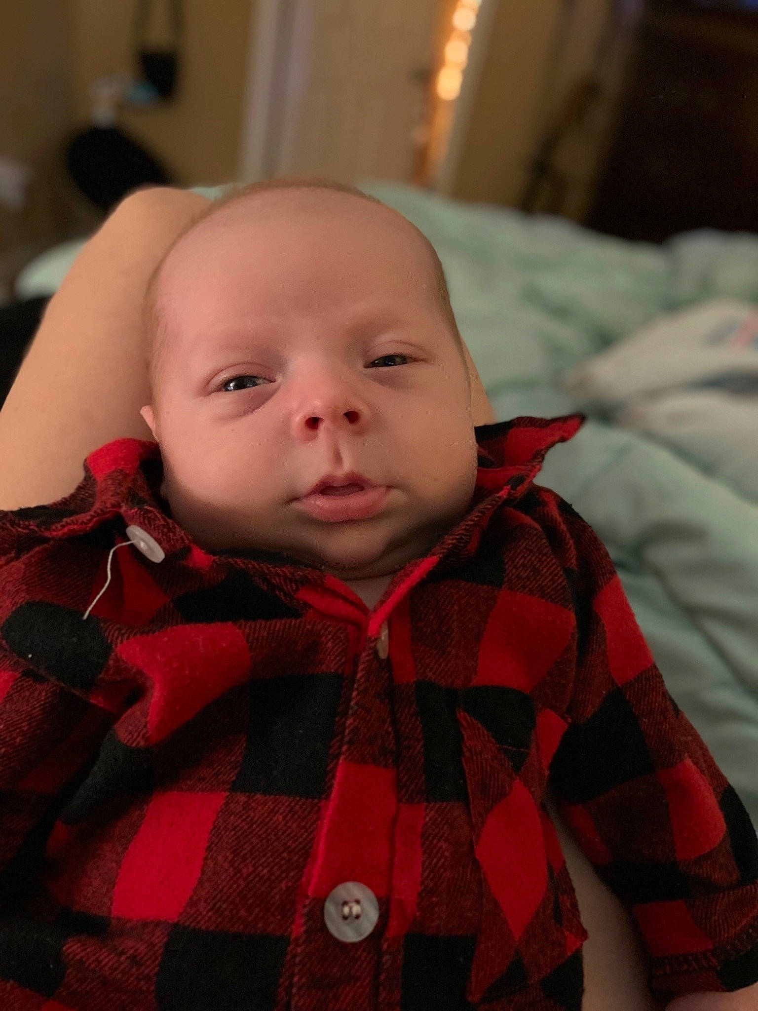 Levi is registered to the contest to win money with this photo: baby, baby_toddler_clothing, cheek, child, chin, collar, comfort, iris, linens, lip, mouth, nose, orange, pattern, person, plaid, skin, sleeve, tartan, textile