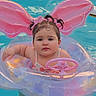 Samara joined the competition — help win amazing prizes! baby, child, pool, swimming, float, inflatable_float, butterfly, pink, water, outdoor, summer, steering_wheel, sitting, portrait, face, hair_bows, swimsuit, recreation, playful, photography
