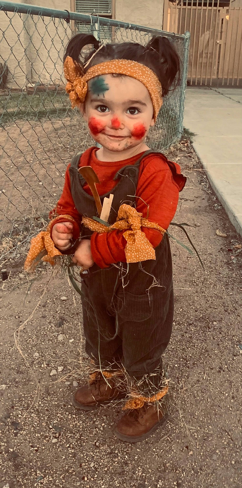 Kinsley joined the competition — help win amazing prizes! art, costume, eye, fence, fictional_character, fun, happy, headgear, human_body, joy, mesh, orange, people_in_nature, person, personal_protective_equipment, sitting, smile, soil, toddler, tradition