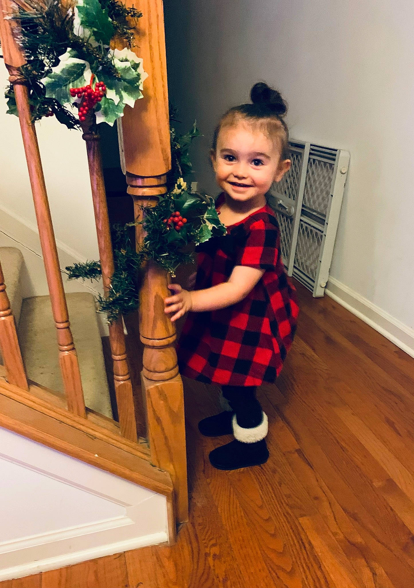 Kinsley is registered to the contest to win money with this photo: baby_toddler_clothing, door, dress, event, flooring, flower_arranging, happy, hardwood, joy, pattern, person, plaid, room, smile, sock, stairs, standing, tartan, toddler, white