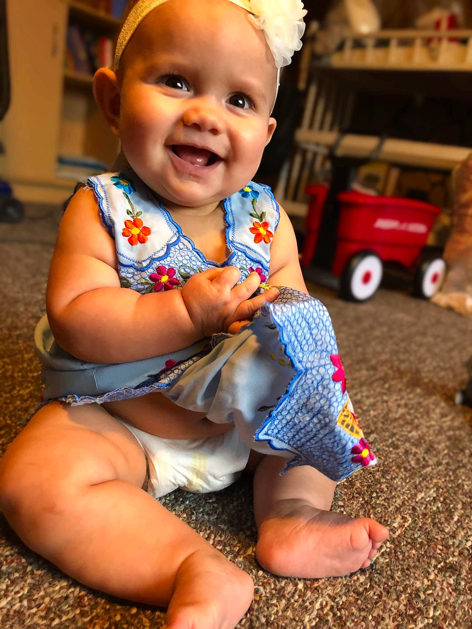 Ellianna is registered to the contest to win money with this photo: baby, baby_toddler_clothing, blue, child, dress, eye, facial_expression, finger, fun, happy, head, human, joy, person, photograph, pink, red, skin, smile, standing
