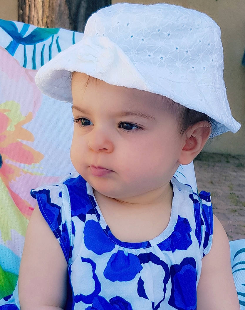 Iliana a rejoint le concours — aidez-le/la à gagner de superbes lots ! baby, baby_toddler_clothing, bonnet, cap, child, clothing, costume_accessory, face, fashion_accessory, hat, head, headgear, headwear, person, skin, smile, summer, sun_hat, toddler, vacation