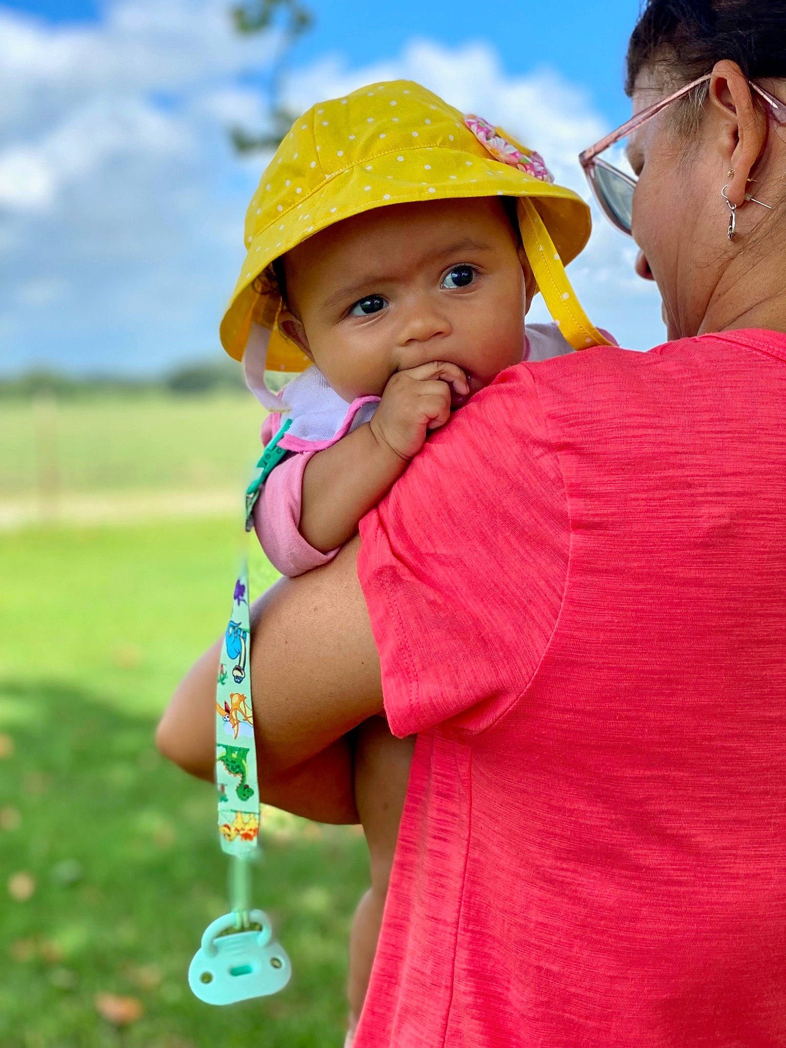 Bella Rae joined the competition — help win amazing prizes! azure, baby, blue, cap, fun, gesture, grass, happy, hat, headgear, headwear, leisure, people_in_nature, person, pink, recreation, shoulder, skin, sky, sun_hat