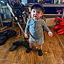 Ronan joined the competition — help win amazing prizes! cap, child, cups, expression, floor, floor_clutter, furniture, gaming_controller, hat, high_chair, indoor, long_sleeve_shirt, person, shelf, shoes, shorts, slippers, toddler, toy, wooden_floor