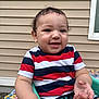 toddler, child, smiling, striped_shirt, curly_hair, outdoor, seat, green_seat, happy, baby, window, siding, arm, hand, casual_clothing, playful, portrait, young_child, daylight, person