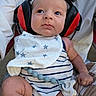 Zayn joined the competition — help win amazing prizes! baby, infant, ear_protectors, headphones, bib, striped_clothing, person, arm, hand, face, blue_eyes, pacifier_clip, outdoor, seated, closeup, cute, child, expression, adult, white_shirt