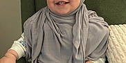 Dimah joined the competition — help win amazing prizes! baby, babylaughing, clothing, couch, cushion, face, furniture, happy, hat, head, homedecor, pants, people, person, photography, portrait, scarf, sitting, smile, standing