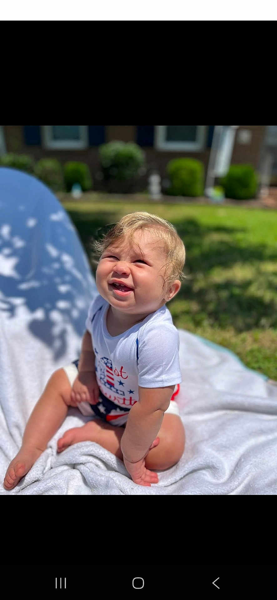 Carsen is registered to the contest to win money with this photo: baby, child, smiling, outdoor, grass, blanket, sunlight, happy, face, toddler, sitting, nature, greenery, daylight, casual_clothing, cute, portrait, infant, young_child, playful