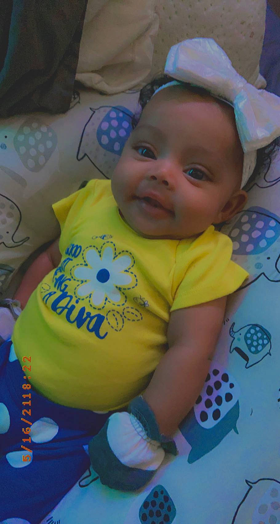 Ari is registered to the contest to win money with this photo: baby, baby_laughing, baby_products, baby_toddler_clothing, blue, cheek, child, fun, happy, mouth, nose, pattern, person, play, purple, sitting, skin, sleeve, smile, t_shirt