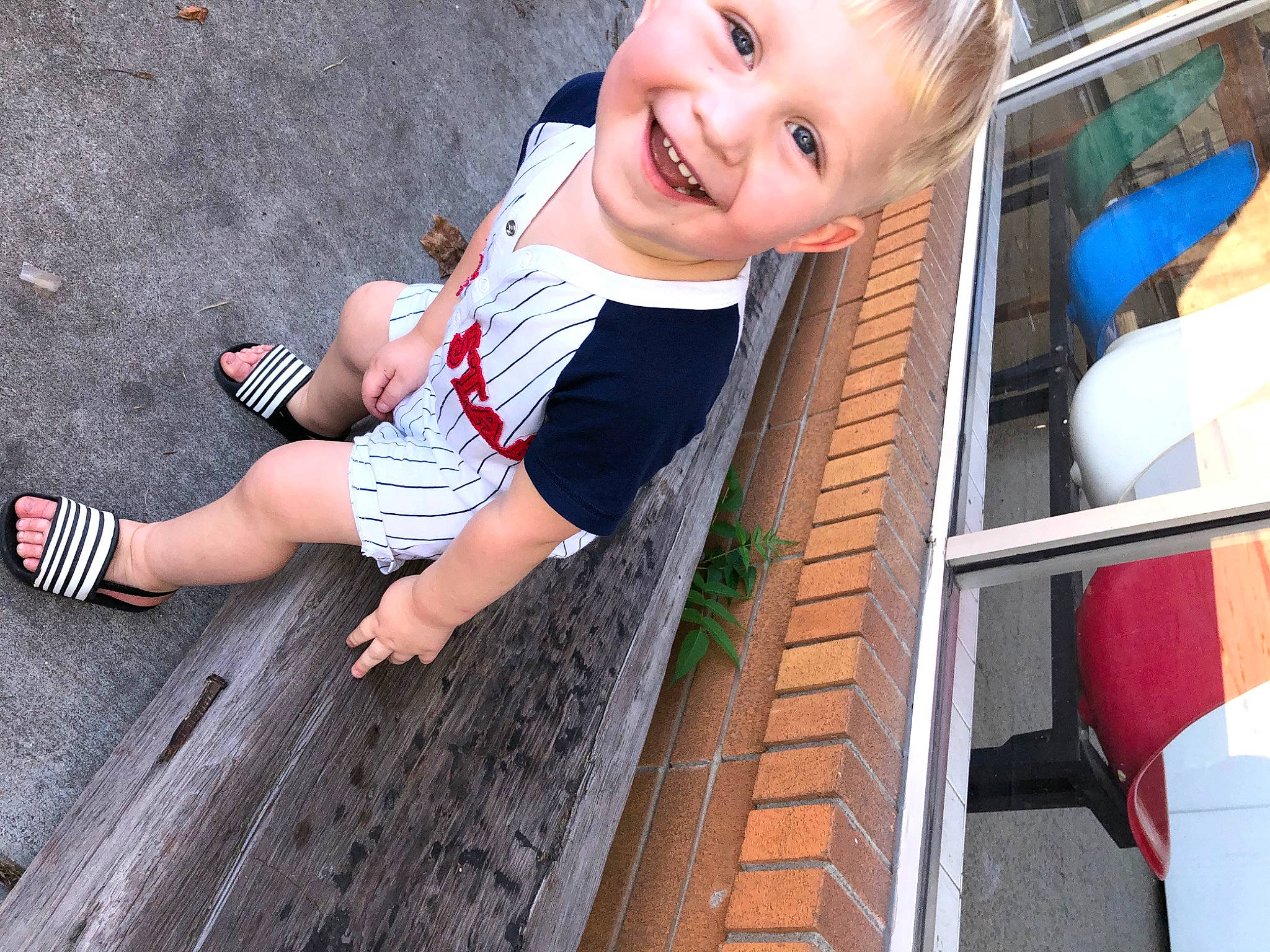 Huntley is registered to the contest to win money with this photo: baby, baby_toddler_clothing, child, electric_blue, foot, fun, grass, happy, human_leg, joy, leisure, people, people_in_nature, person, play, sitting, smile, sock, standing, thigh