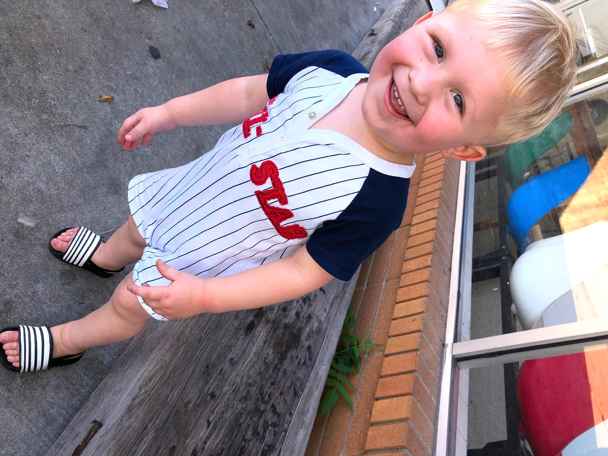 Huntley is registered to the contest to win money with this photo: calf, child, elbow, electric_blue, foot, fun, happy, human_leg, joy, knee, leisure, person, recreation, shorts, smile, street_fashion, t_shirt, thigh, toddler, waist